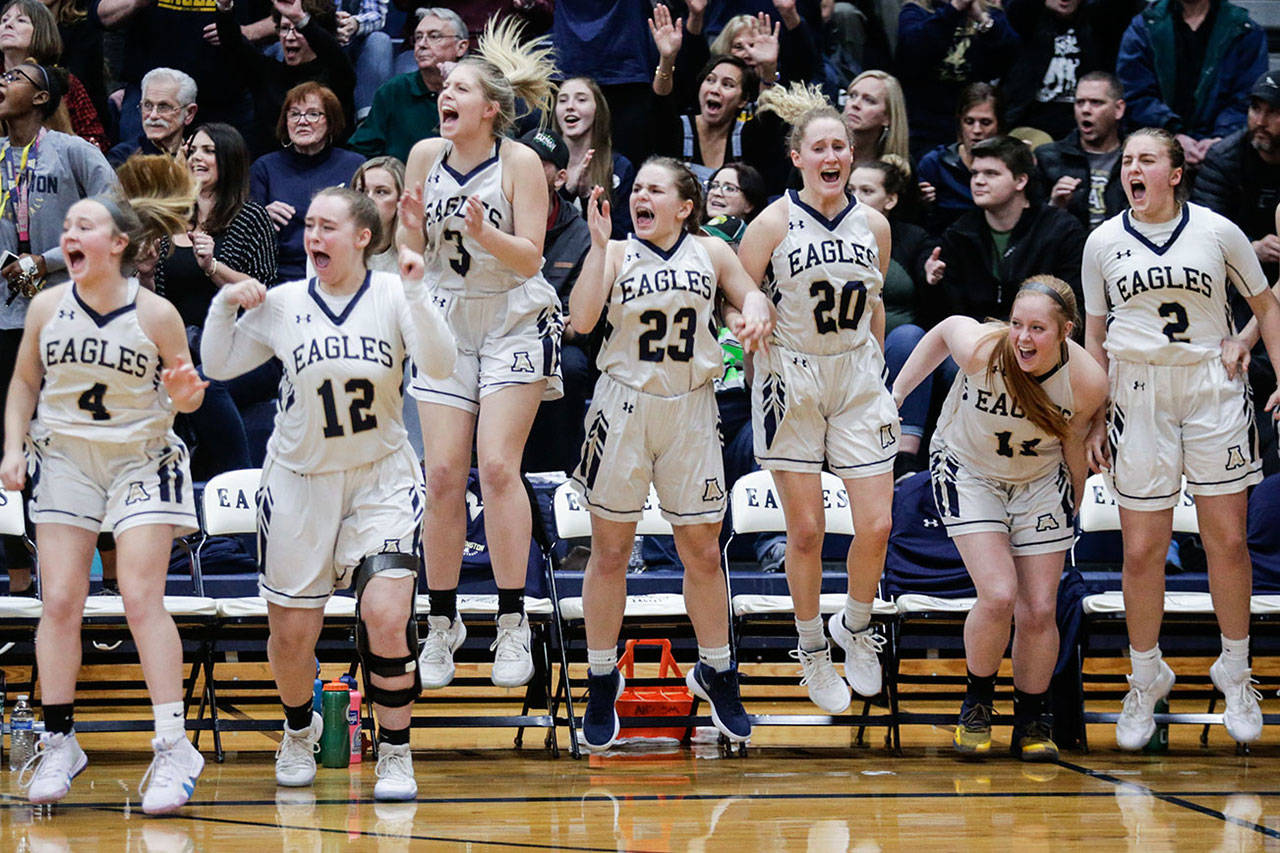 Arlington players celebrate as the Eagles beat Snohomish 40-38 in a girls’ basketball game on Friday in Arlington. (Andy Bronson / The Herald)