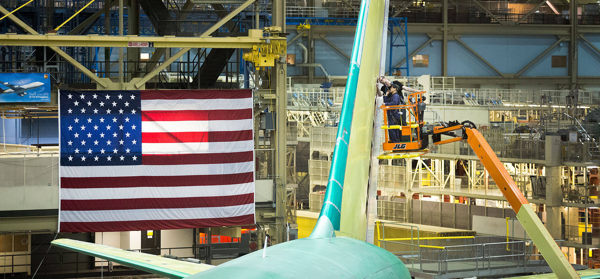 Boeing employees work on the vertical stabilizer of a 767 cargo plane in the Boeing factory in May 2017 in Everett. (Andy Bronson / Herald file)