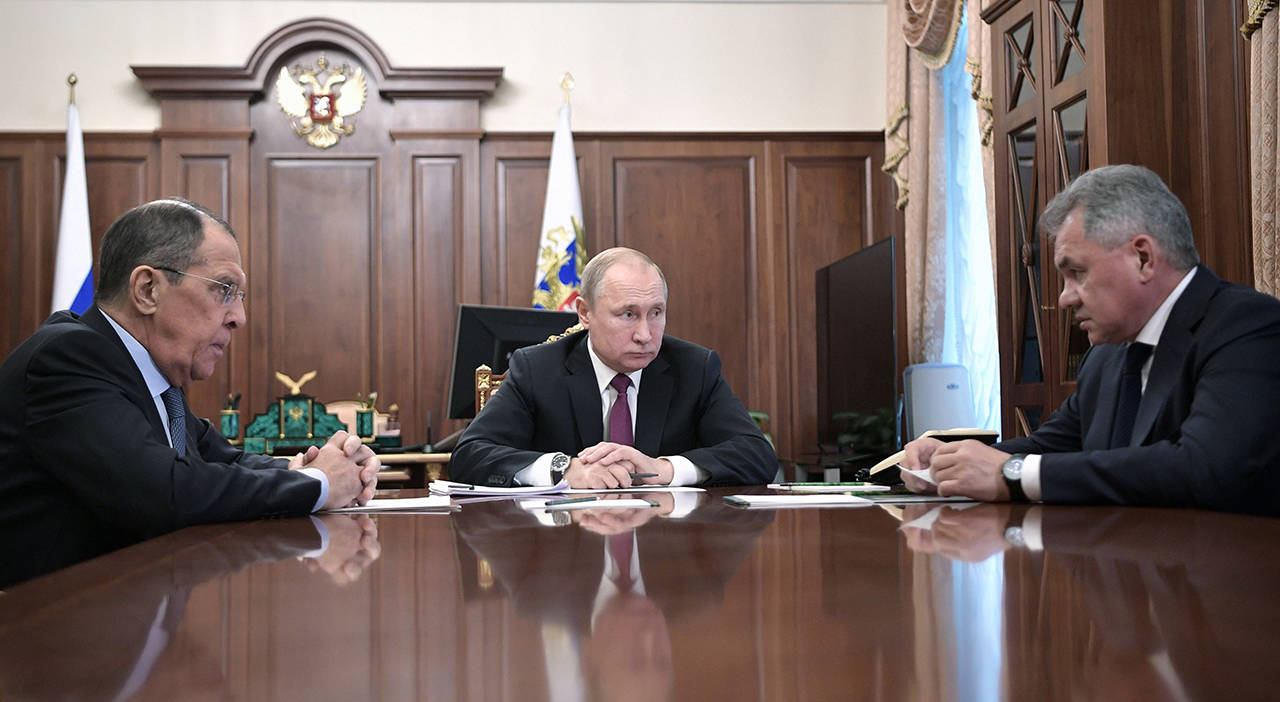 Russian President Vladimir Putin (center) attends a meeting with Russian Foreign Minister Sergey Lavrov and Defense Minister Sergei Shoigu in the Kremlin in Moscow, Russia, on Saturday. (Alexei Nikolsky, Sputnik, Kremlin Pool Photo via AP)