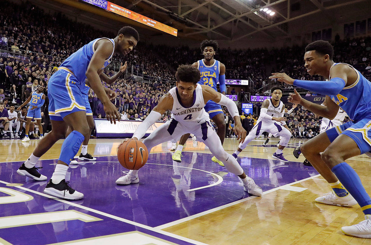 Washington guard Matisse Thybulle (center) drives between UCLA forward Cody Riley (left) and guard Jaylen Hands after making a steal during a game on Feb. 2, 2019, in Seattle. (AP Photo/Ted S. Warren)