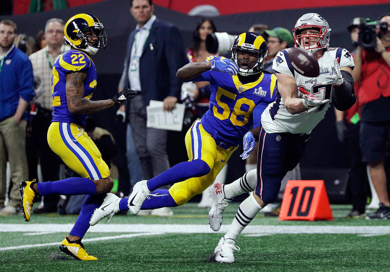 New England Patriots tight end Rob Gronkowski (87) catches a pass in front of Los Angeles cornerback Marcus Peters (22) and linebacker Cory Littleton (58) during the second half Sunday’s Super Bowl in Atlanta. (AP Photo/David J. Phillip)