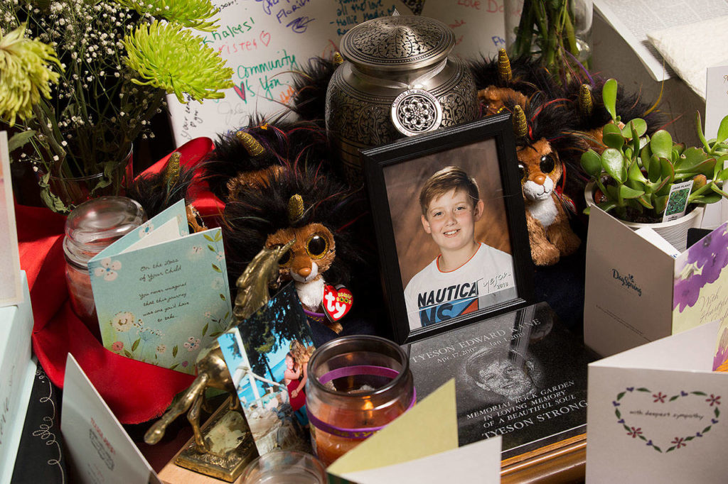 An urn is surrounded by cards and other items offering support to Jhade Tolman. Her son, Tyeson Kane, was sledding in the small town of Pateros when he was struck by a truck. (Andy Bronson / The Herald) 
