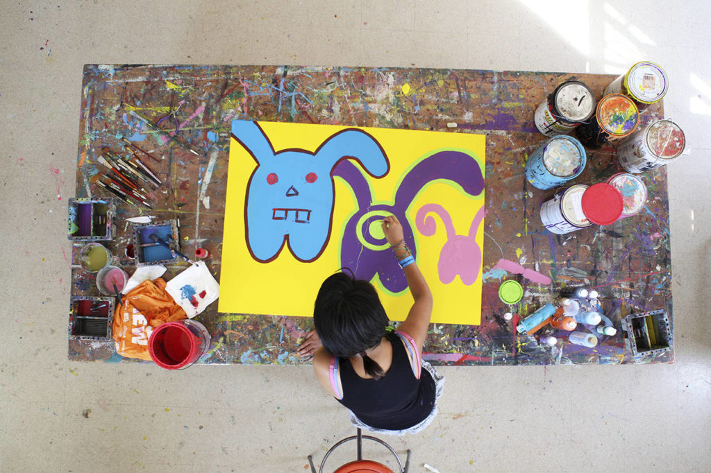 Inocente, an undocumented teen, paints “Masters of Disguise” in the film “Inocente.” (Sean Fine)
