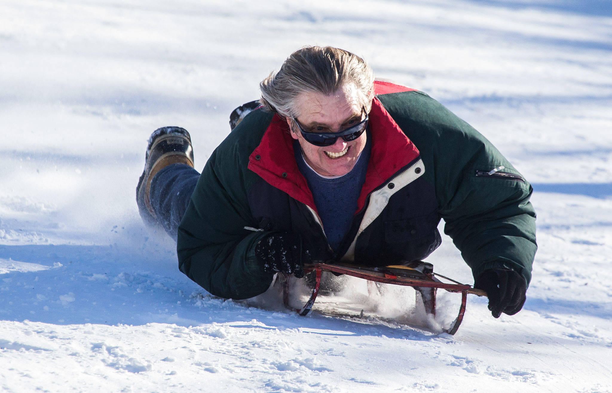 Don Hillstrand,63, rockets down a hill on a sled at Forest Park on Wednesday in Everett. He said he has had the sled since he was 14 and has wrecked it and rebuilt it many times. (Andy Bronson / The Herald)