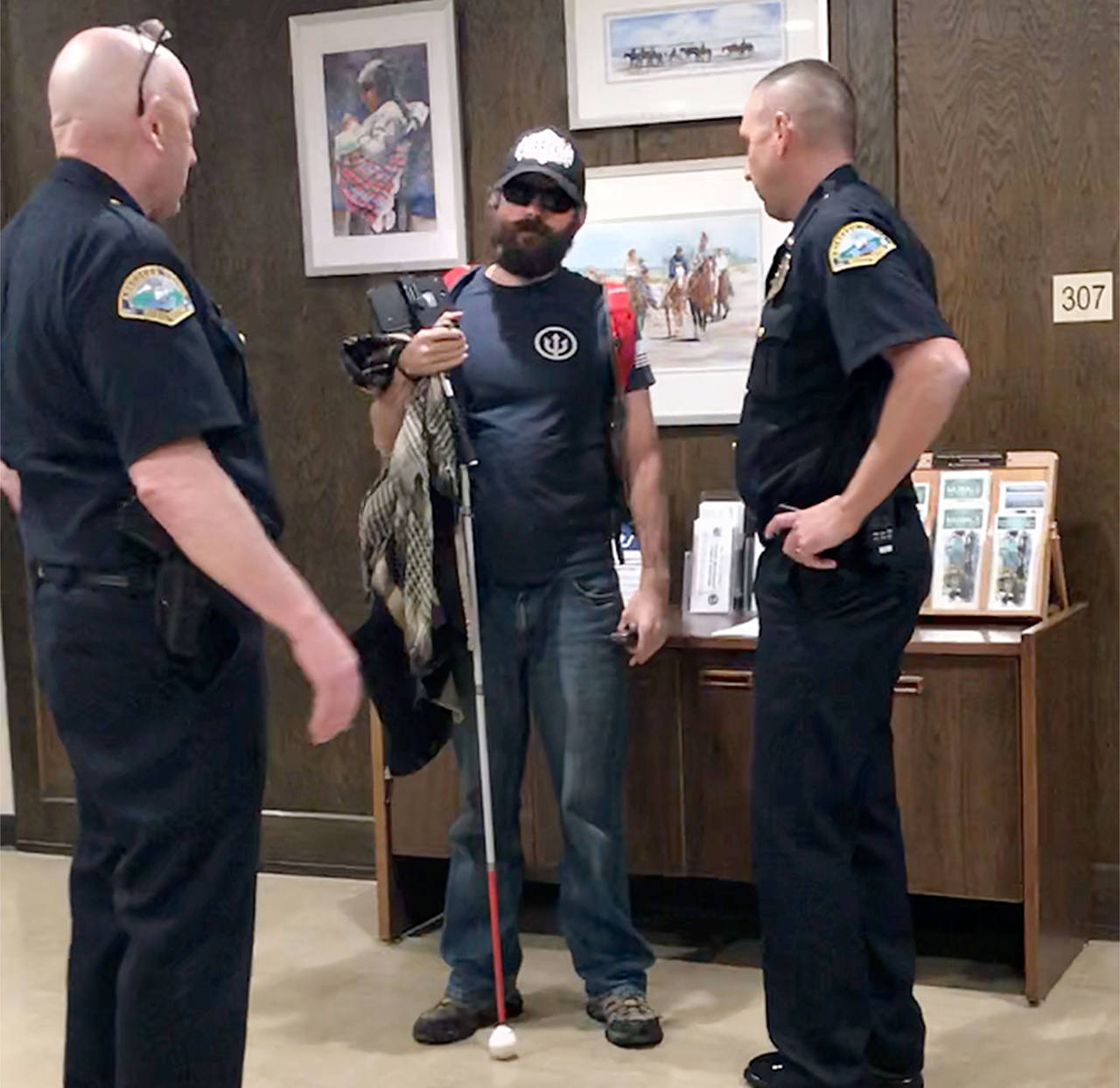 Mike Nelson (middle), aka Blind Justice, speaks with Aberdeen Deputy Police Chief Dave Timmons (left) and Chief Steve Shumate (right). (Louis Krauss / Grays Harbor News Group)