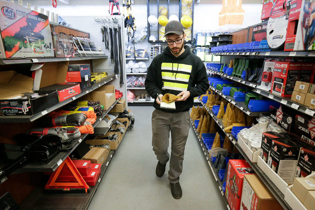 Employee Jacob Mastro works on a customer’s order at Greenshields Industrial Supply in Everett. (Andy Bronson / The Herald) 
