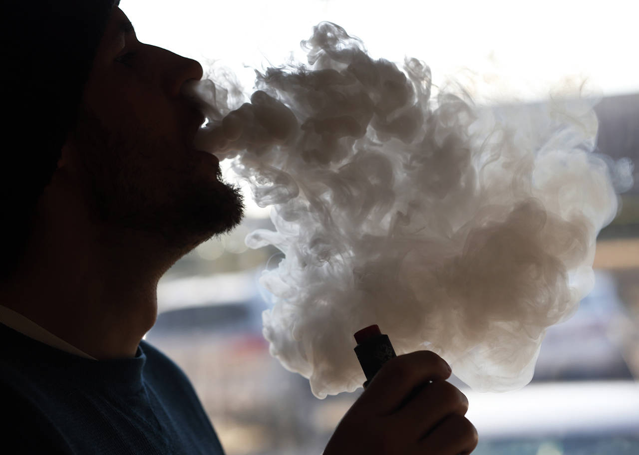 A man emits a cloud of smoke from a vape pipe in Richmond, Virginia, on Jan. 18. A Texas man died after a vape pen exploded in his mouth on Jan. 27. (AP Photo/Steve Helber, file)