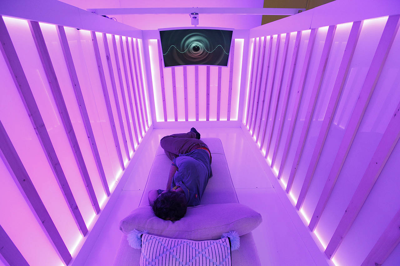 An attendee tests the Miku baby sleep and breathing monitor at the Miku booth at CES International on Wednesday in Las Vegas. (AP Photo/John Locher)