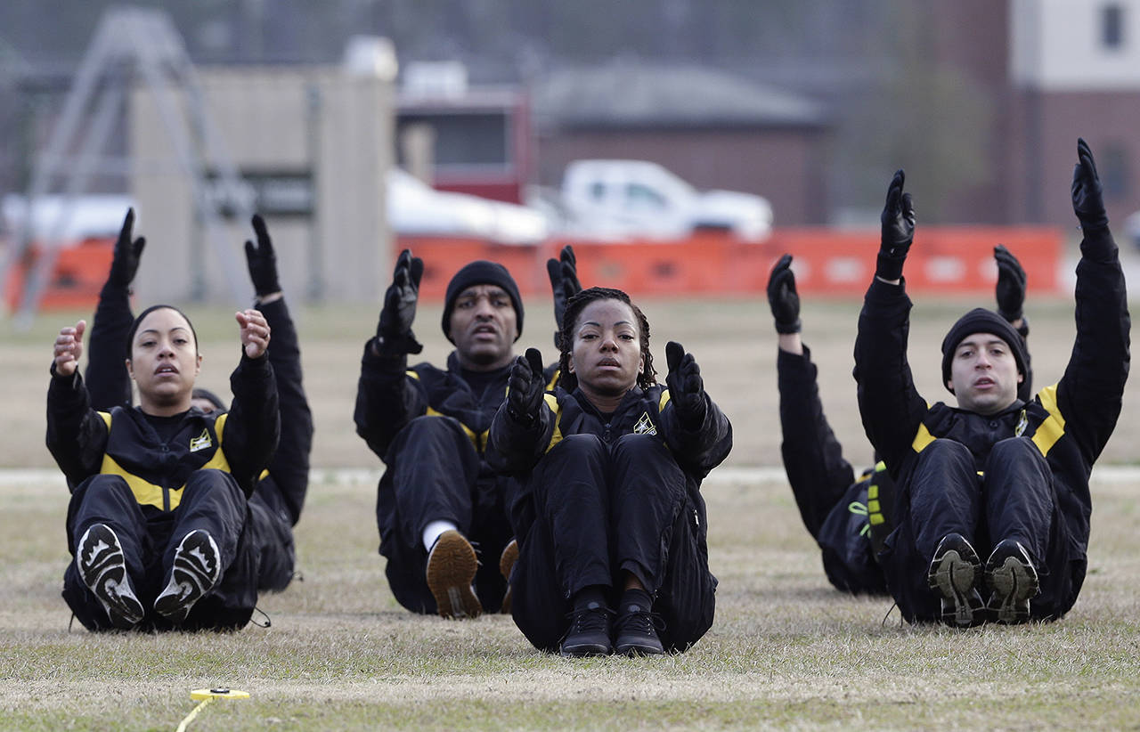U.S Army troops in training to become instructors participate in the new Army combat fitness test Tuesday at the 108th Air Defense Artillery Brigade compound at Fort Bragg, North Carolina. The new test is designed to be a more accurate test of combat readiness than the present requirements. (AP Photo/Gerry Broome)