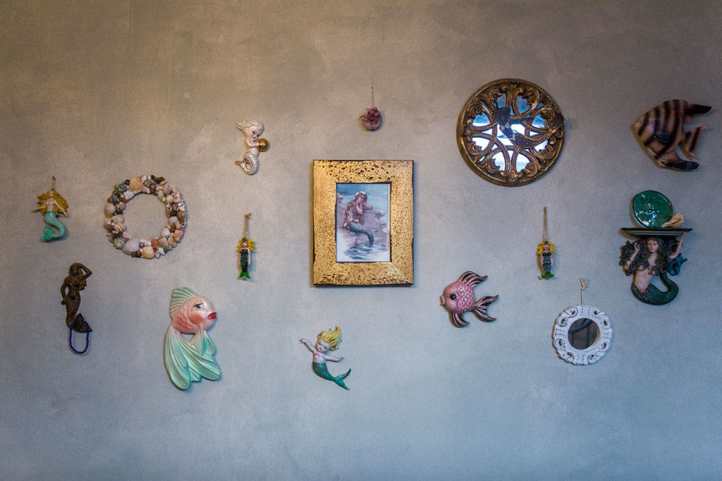 Mermaids and other sea-themed items hang on the wall of the mermaid room. (Olivia Vanni / The Herald)
