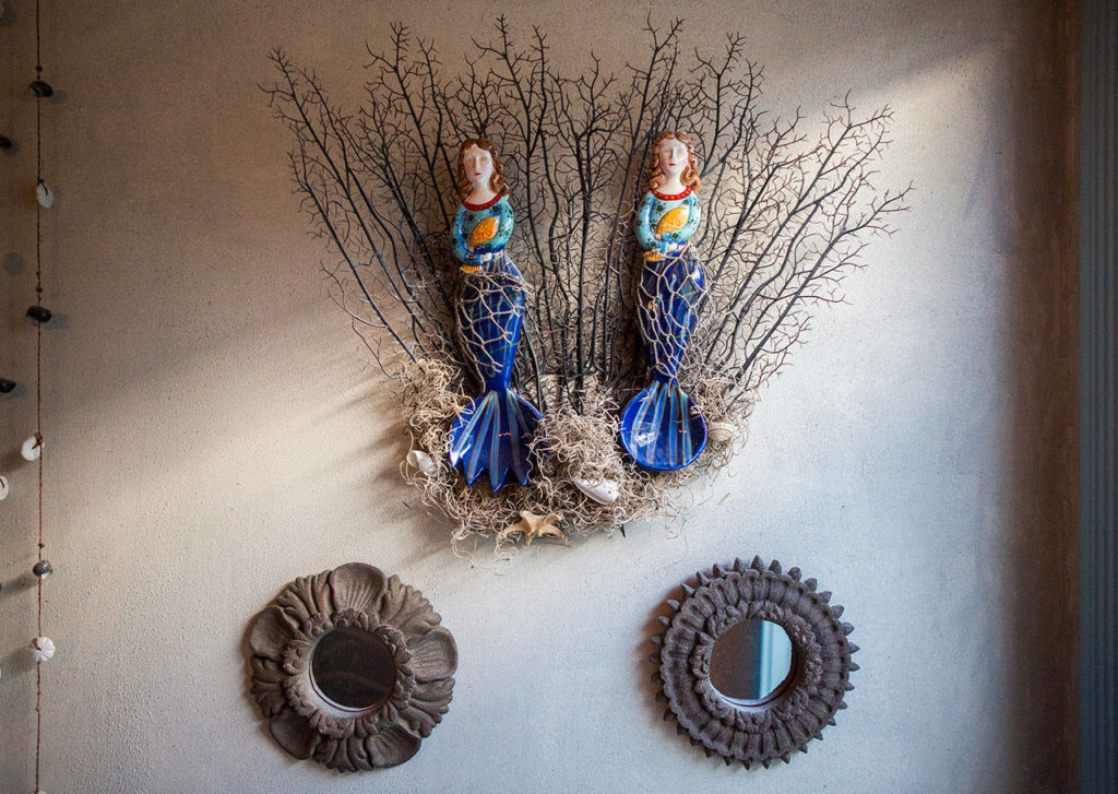 Mermaid-themed items hang next to the bed in the mermaid room. (Olivia Vanni / The Herald)
