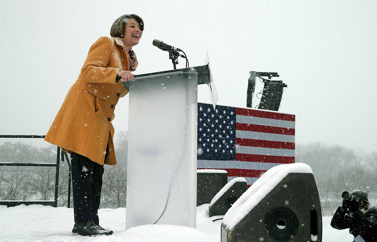 Democratic Sen. Amy Klobuchar addresses a snowy rally Sunday at Boom Island Park in Minneapolis where she announced she is entering the race for president. (AP Photo/Jim Mone)