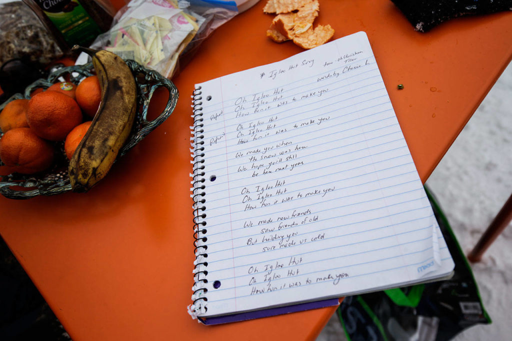 The “Igloo Hut” song lyrics by Cherie Hansen, sung to the tune of “O Christmas Tree,” written in a notebook at Rucker Park on Monday in Everett. (Andy Bronson / The Herald) 
