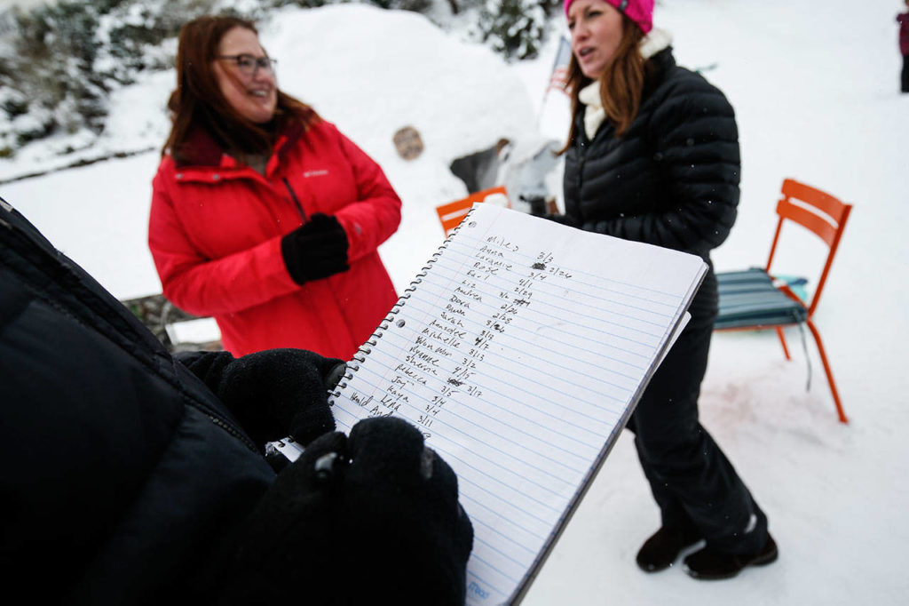 Neighbors choose dates when they guess the igloo will fully melt, with only grass showing. (Andy Bronson / The Herald) 
