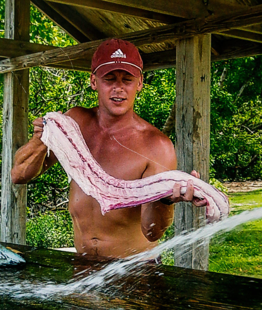 Jeffrey Saari, shown here cleaning his catch in Florida, died of a heroin overdose in 2009 at age 33. Nearly eight years later, his older brother Ed also died from an overdose.
