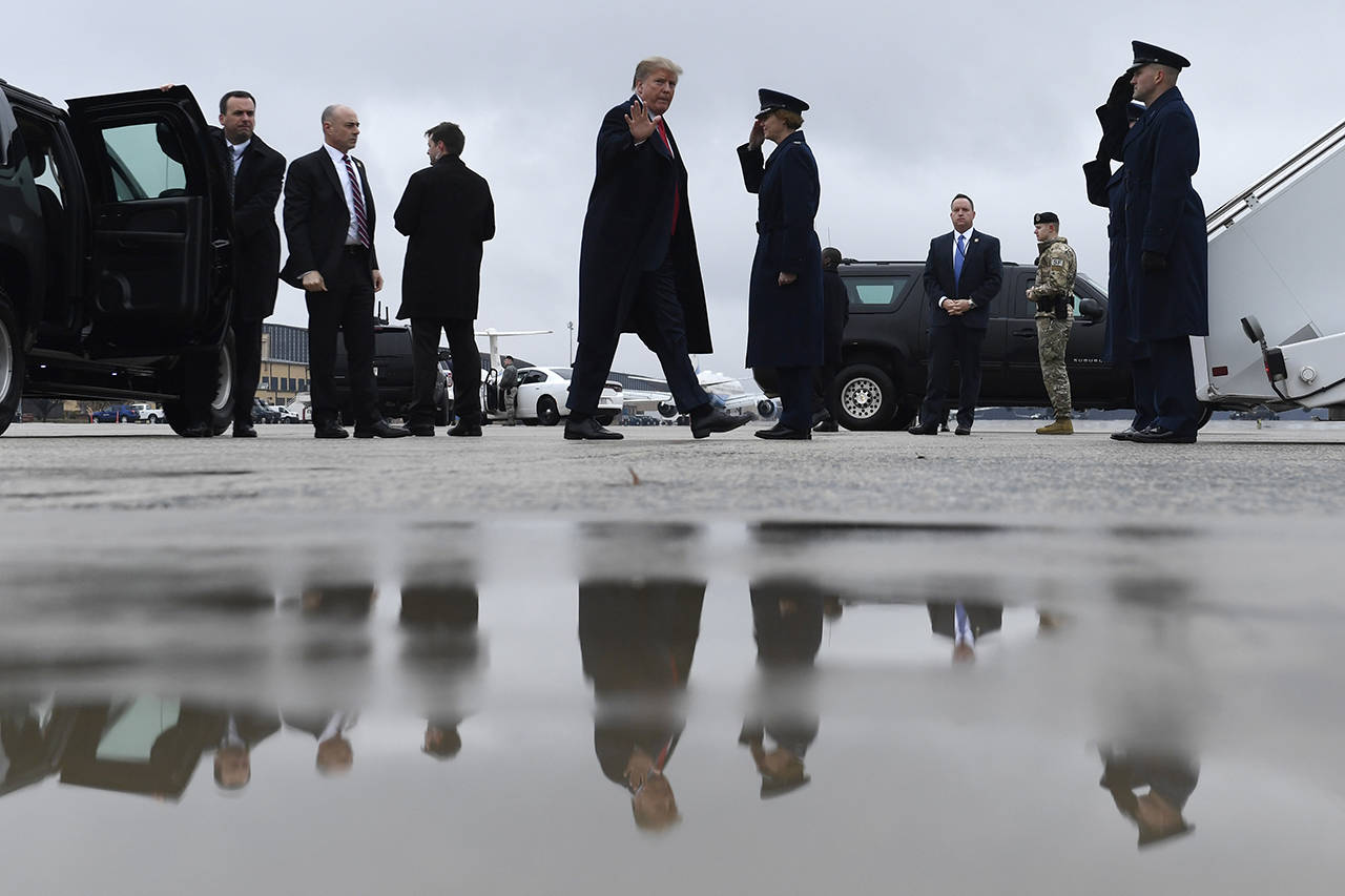President Donald Trump waves as he arrives to board Air Force One at Andrews Air Force Base in Maryland on Monday. (AP Photo/Susan Walsh)