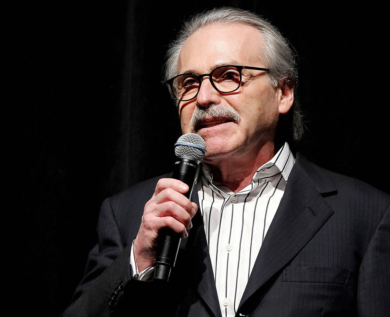 In this 2014 photo, David Pecker, Chairman and CEO of American Media, addresses those attending the Shape & Men’s Fitness Super Bowl Party in New York. (Marion Curtis via AP, File)
