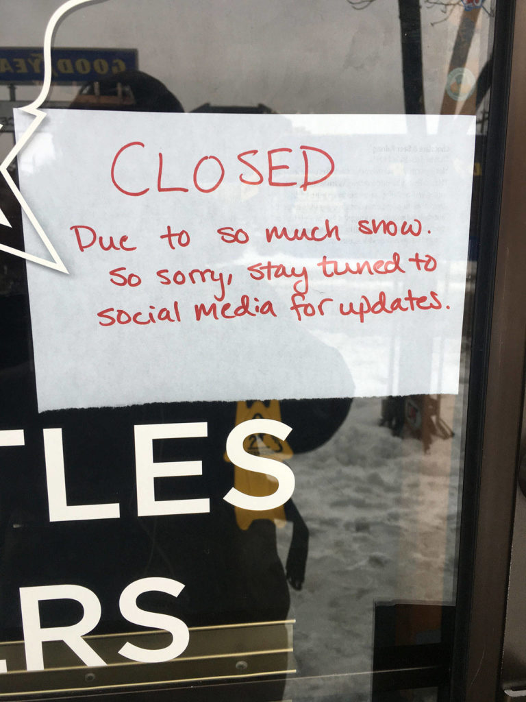 The high amount of accumulating snowfall made it a challenge for some businesses, such as Toggle’s Bottleshop, which had closed Tuesday, Feb. 12, to stay open every day for their thirsty customers. (Ben Watanabe / The Herald)
