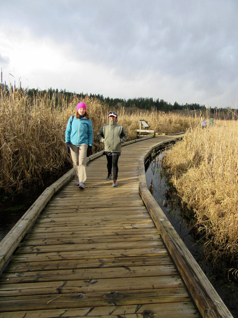 Heather Romano and Delfina McCoy on the boardwalk at North Creek Trail in Mill Creek. The two-mile trail is close to the city center. (Craig Romano)
