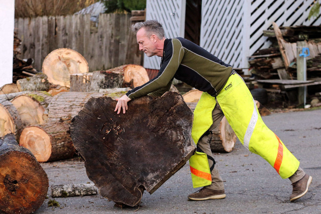 Shane McDaniel relocates wood at his home Jan. 12, in Lake Stevens. His good deeds landed him on a dating show segment during the Steve Harvey talk show, where McDaniel and his twin sons chose from three eligible bachelorettes, including a woman from Lake Stevens. (Kevin Clark / The Herald)
