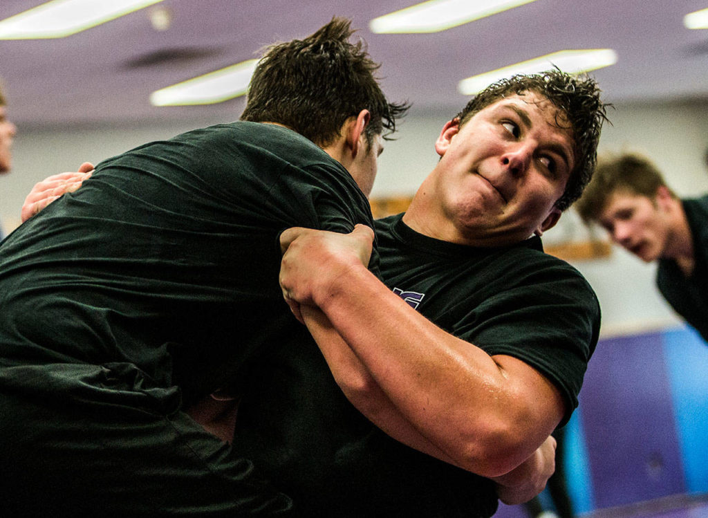Lake Stevens’ Devin Kylany attempts to take down teammate Wyatt Hall during a Wednesday practice session at Lake Stevens. (Olivia Vanni / The Herald)

