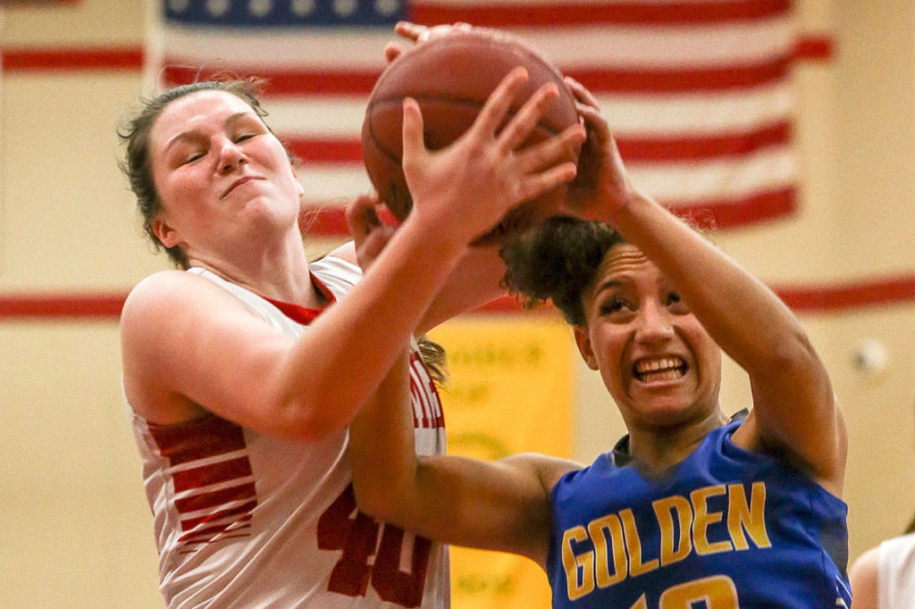 Snohomish’s Courtney Perry (left) and Ferndale’s Aleah Washington struggle for a rebound Wednesday at Snohomish High School. (Kevin Clark / The Herald)
