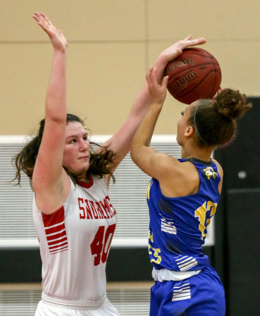 Snohomish’s Courtney Perry (left) blocks Ferndale’s Aleah Washington shot attempt Wednesday at Snohomish High School. (Kevin Clark / The Herald)
