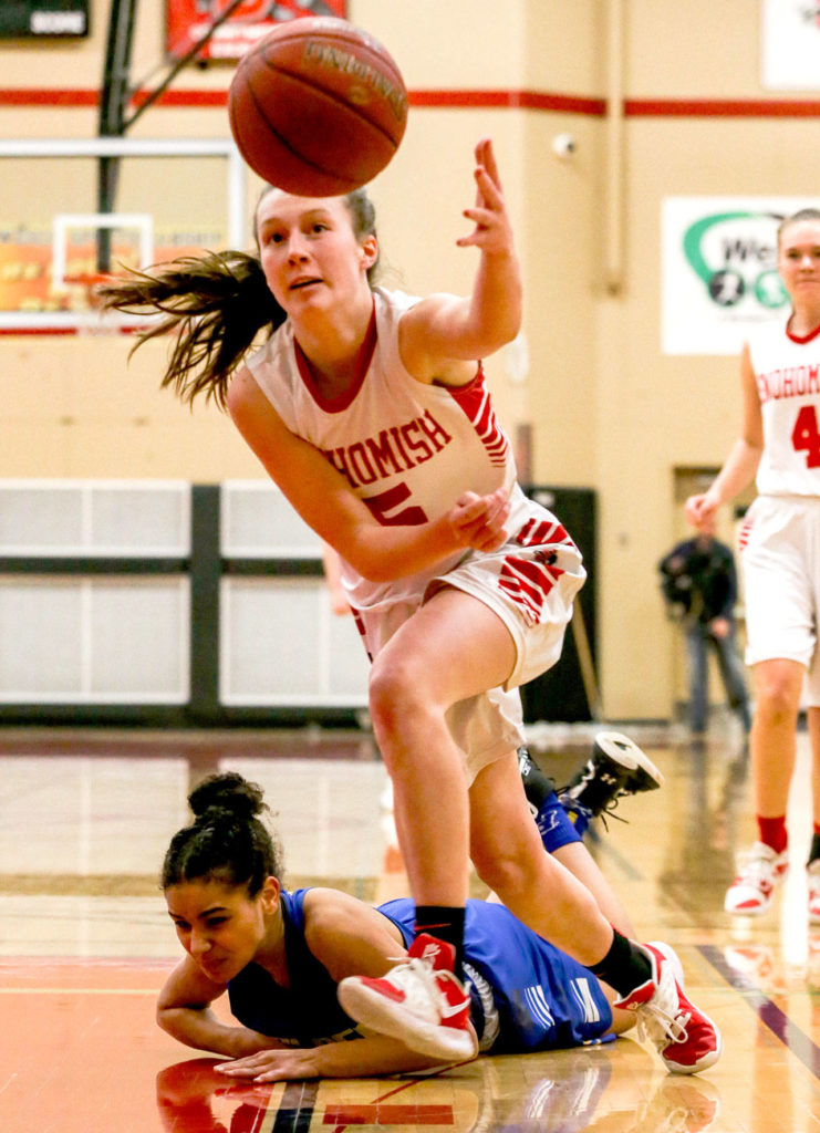 Snohomish’s Ella Gallatin reaches for a loose ball with Ferndale’s Brianna Byrnes trailing Wednesday at Snohomish High School. (Kevin Clark / The Herald)
