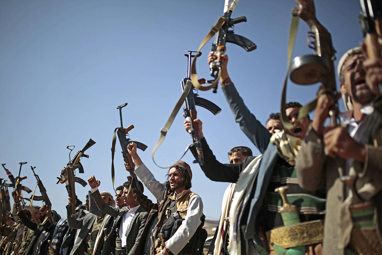 In this Dec. 13, 2018, photo, tribesmen loyal to Houthi rebels hold up their weapons as they attend a gathering to show their support for the ongoing peace talks in Sanaa, Yemen. Asserting Congress’ authority over war powers, the House is debating a resolution to force the Trump administration to withdraw U.S. troops from involvement in Yemen. (AP Photo/Hani Mohammed, File)