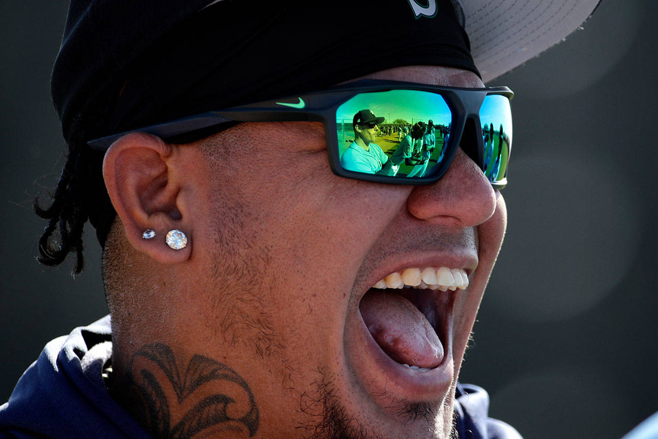 Seattle’s Felix Hernandez laughs with teammates during a spring training practice session Tuesday in Peoria, Ariz. (AP Photo/Charlie Riedel)