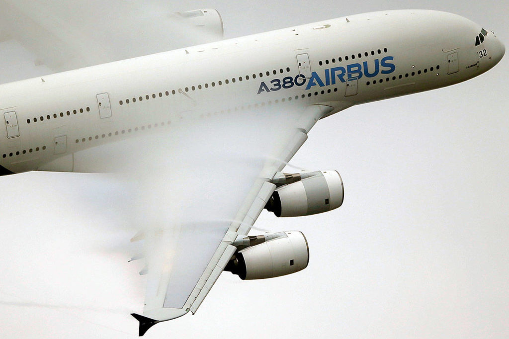 Vapor flows across the wings of an Airbus A380 as it performs a demonstration flight at the Paris Air Show, in 2015. (AP Photo/Francois Mori, File) 
