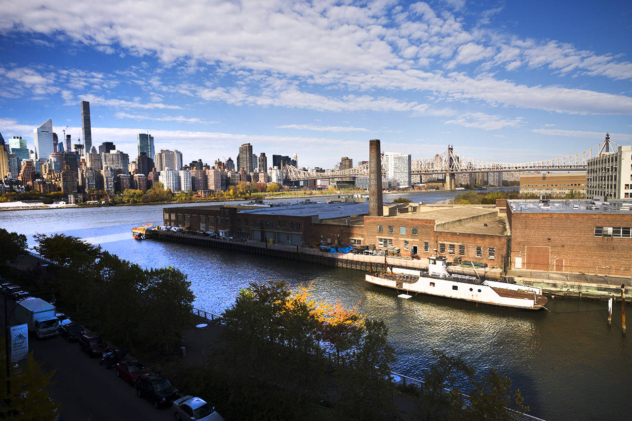 In this Nov. 2018 photo, a rusting ferryboat is docked next to an aging industrial warehouse on Long Island City’s Anable Basin in the Queens borough of New York. Amazon said Thursday that it is dropping New York City as one of its new headquarter locations. (AP Photo/Mark Lennihan, File)