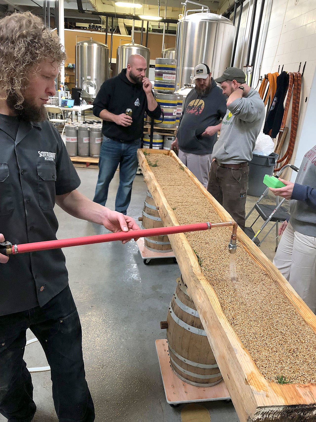 Scuttlebutt Brewings Eric Nord (left) brews with a kuurna, a traditional Finnish lauter tun used to brew sahti. (Photo by Aaron Swaney)