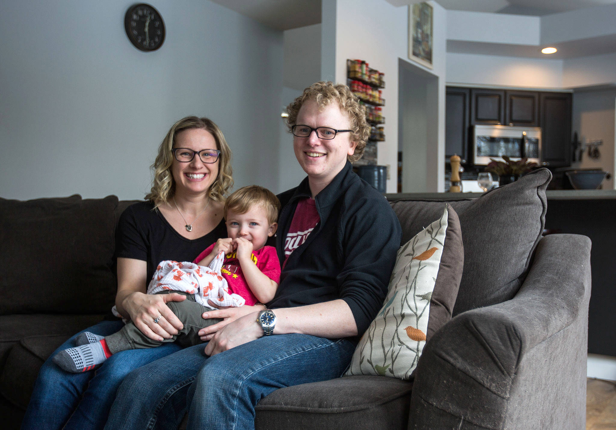 Brianne Hebert (left), son Declan Hebert, 2 (center), and Remington Rohrer relax in their Lake Stevens home. (Olivia Vanni / The Herald)