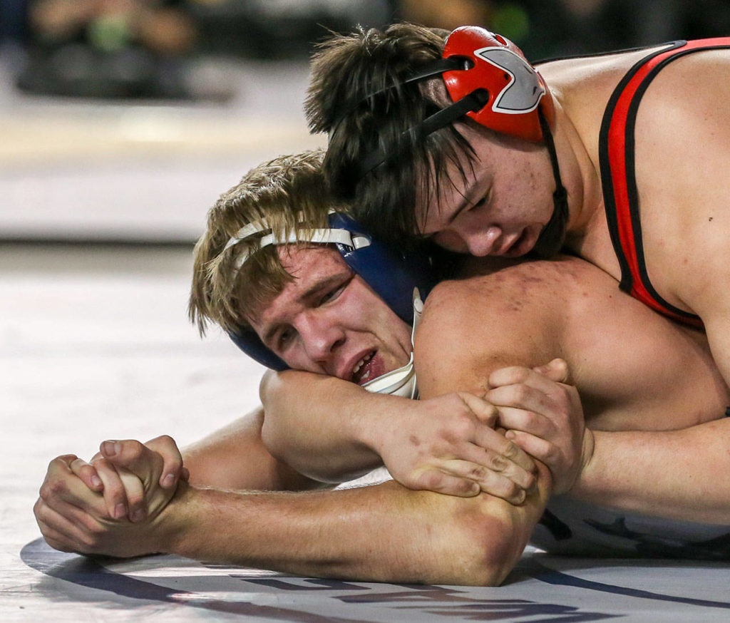 Sultan’s Tyler Deason (left) struggles against Granger’s Gage Cook in the 220 weight class Saturday night during the Mat Classic XXXI at the Tacoma Dome on February 15, 2019 in Tacoma. Deason finished second in state. (Kevin Clark / The Herald)
