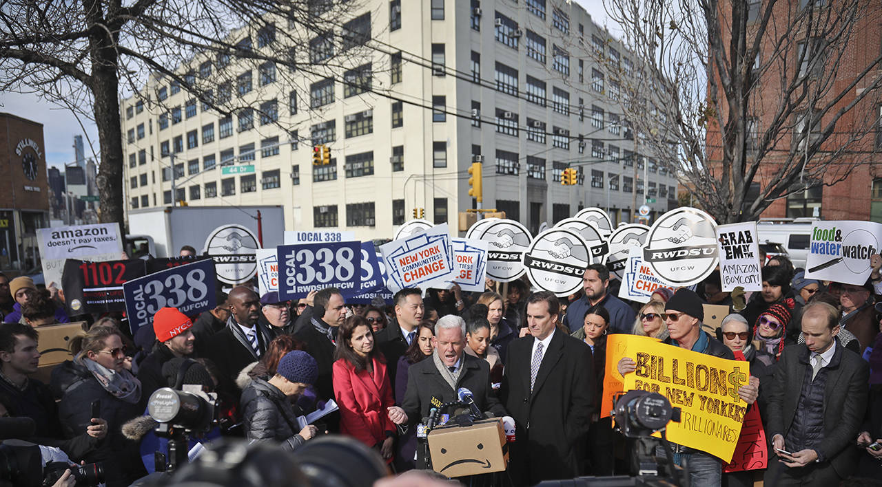 In this Nov. 2018 photo, New York City Councillor Jimmy Van Bramer (center) speaks during a coalition rally and press conference of elected officials, community organizations and unions opposing Amazon headquarters getting subsidies to locate in the New York neighborhood of Long Island City, Queens. (AP Photo/Bebeto Matthews, File)