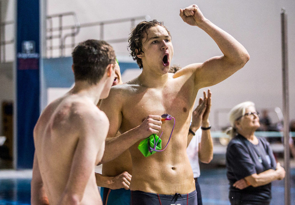 Shorewood senior Jack Brodersen pumps his fist in the air after his team’s sixth-place finish in the 200 medley relay. (Olivia Vanni / The Herald)
