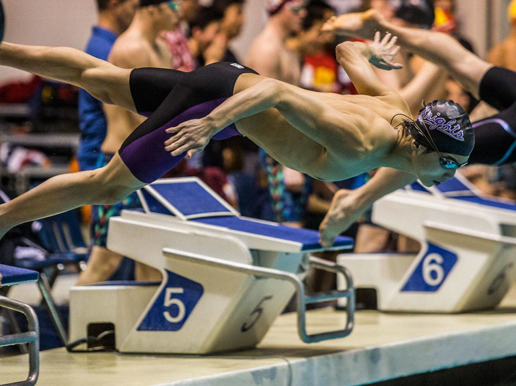 Kamiak dives off the block during its third-place finish in the 200 freestyle relay. (Olivia Vanni / The Herald)
