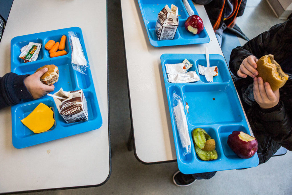 Students eat their cafeteria lunches during lunch at Lynndale Elementary on Friday in Lynnwood. (Olivia Vanni / The Herald)
