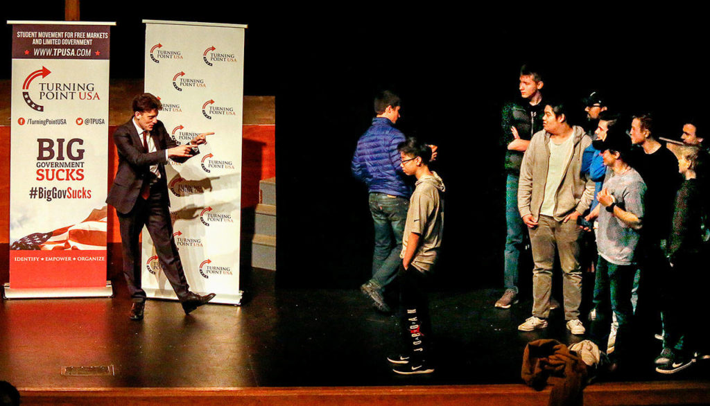 Speaker Kyle Kashuv greets a group of boys who came up on stage to take photos with him following his talk about gun rights and school shootings. (Dan Bates / The Herald)
