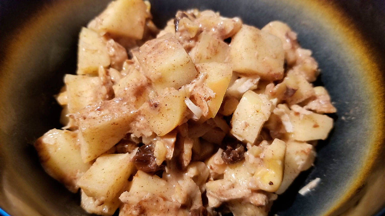 Hot apple-nut cereal is made with sweet apples, chopped nuts, raisins, shredded coconut, coconut milk and cinnamon. (Megan Campbell / The Herald)
