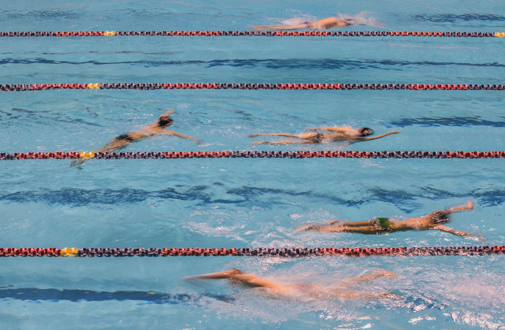 Swimmers warm up before the start of the 4A Boys’ Swim/Dive Championships on Saturday, Feb. 16, 2019 in Federal Way, Wash. (Olivia Vanni / The Herald)