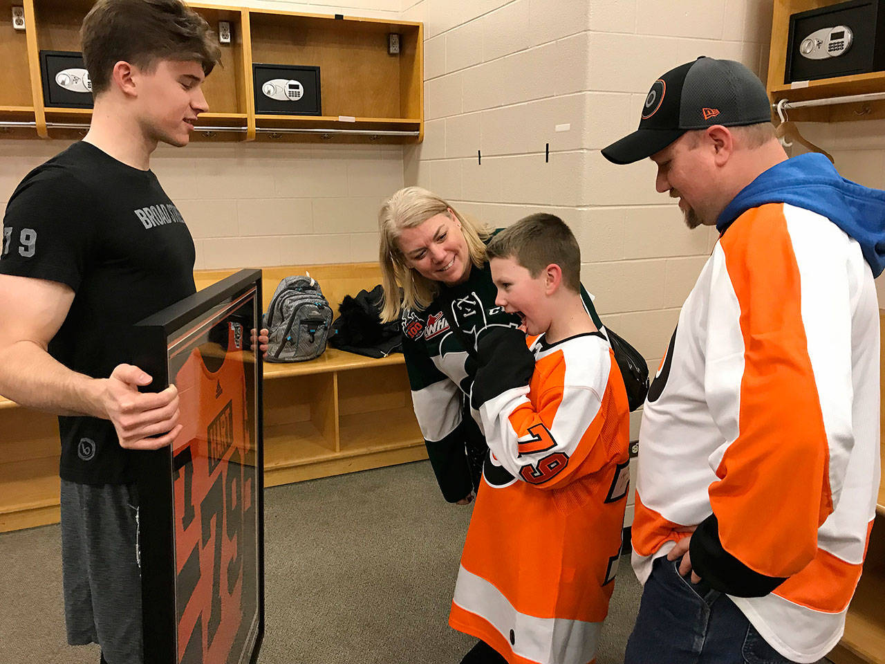 The Philadelphia Flyers’ Carter Hart presents Connor Parkkila with a signed and framed Stadium Series jersey following Tuesday night’s game against Tampa Bay. (Photo courtesy of Philadelphia Flyers)