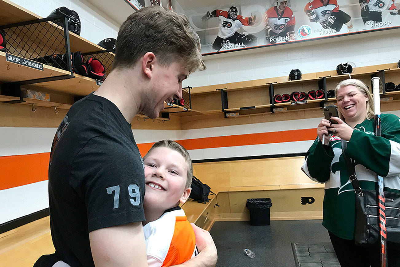 Connor Parkkila hugs his idol, Philadelphia Flyers rookie goalkeeper Carter Hart, on Saturday in the Flyers’ locker room. (Photo courtesy of Philadelphia Flyers)