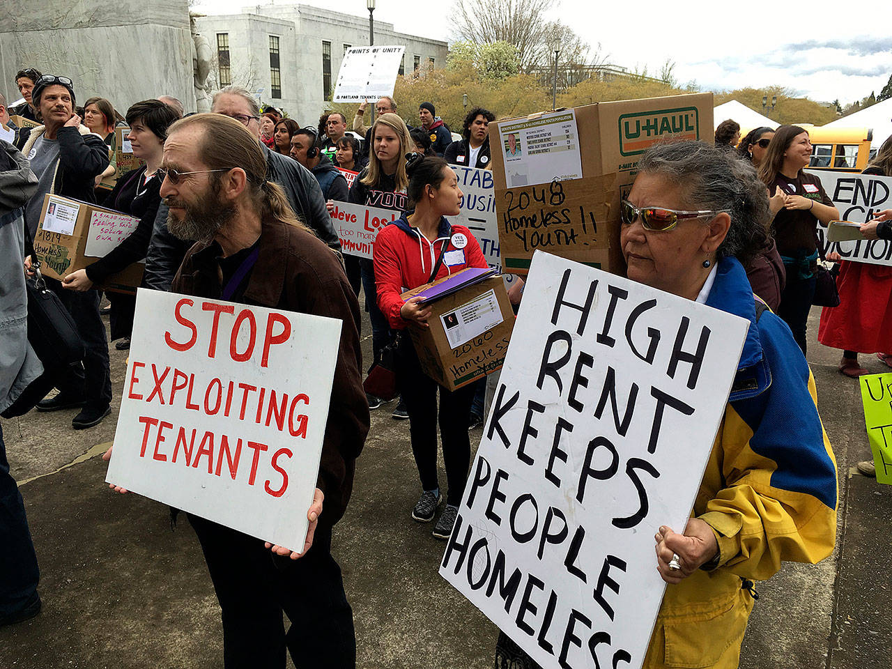 Supporters of a bill to ban most no-cause evictions of home renters in Oregon demonstrate on the Capitol steps in Salem on April 12, 2017. (AP Photo/Andrew Selsky, File)
