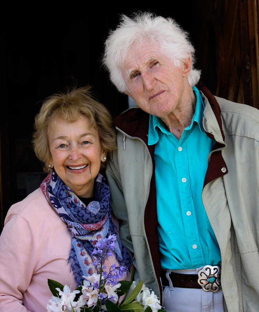 Roberta Brown and Peter Lawlor stand in front of Peter’s sea cottage in Clinton. The carved wood sign, Tusitala, means “teller of tales” in Samoan. (Family photo)
