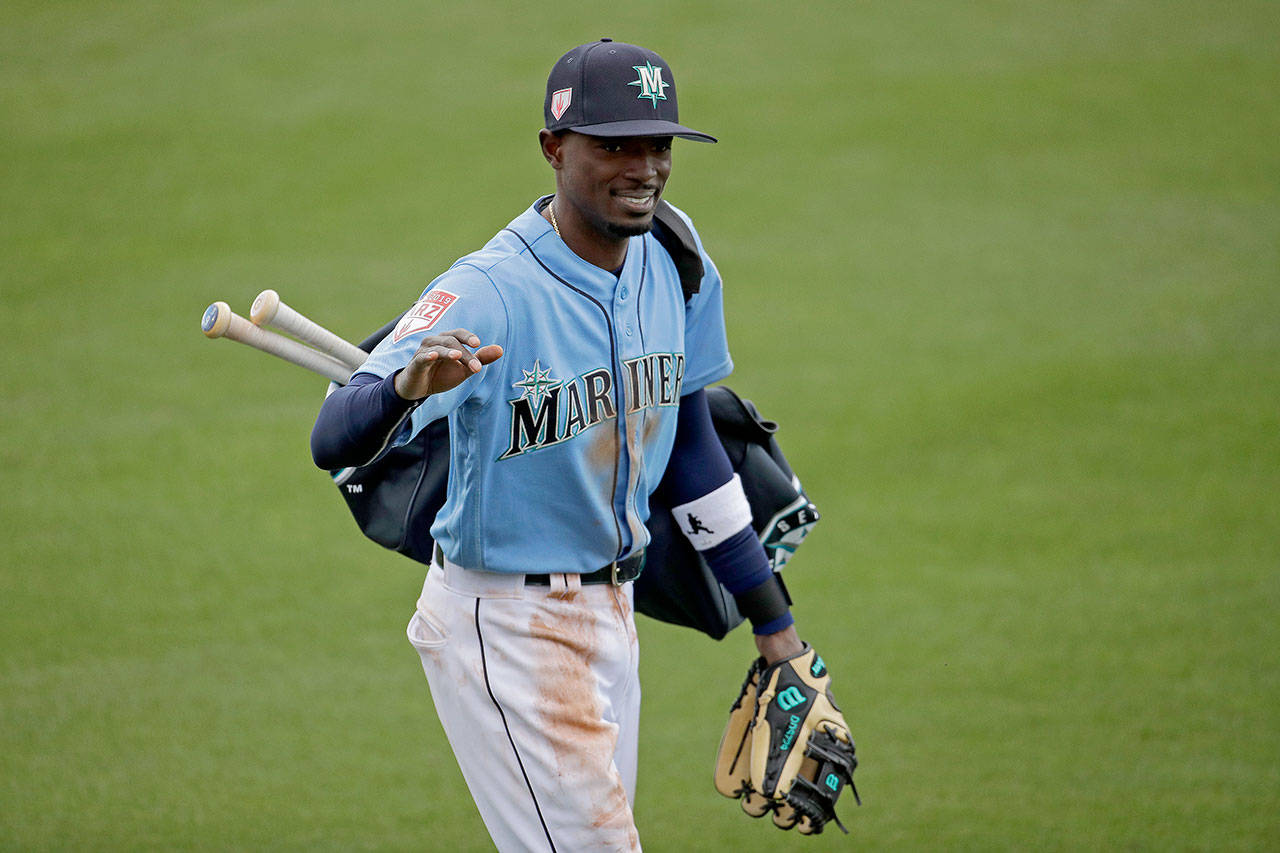 The Mariners’ Dee Gordon walks off the field during the third inning of a spring training game against the Athletics on Feb. 22, 2019, in Peoria, Ariz. (AP Photo/Charlie Riedel)