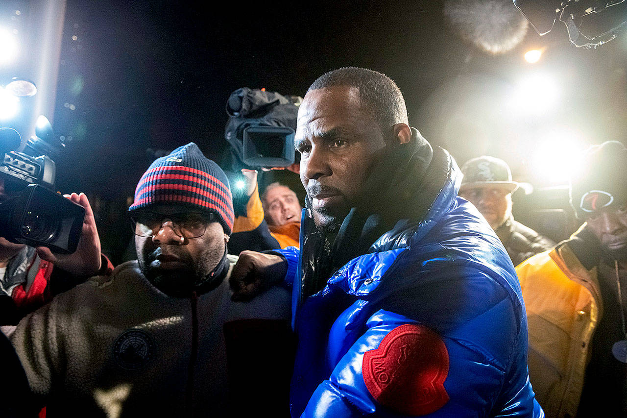 R. Kelly surrenders to authorities at a Chicago police station on Friday. (Tyler LaRiviere/Chicago Sun-Times via AP)