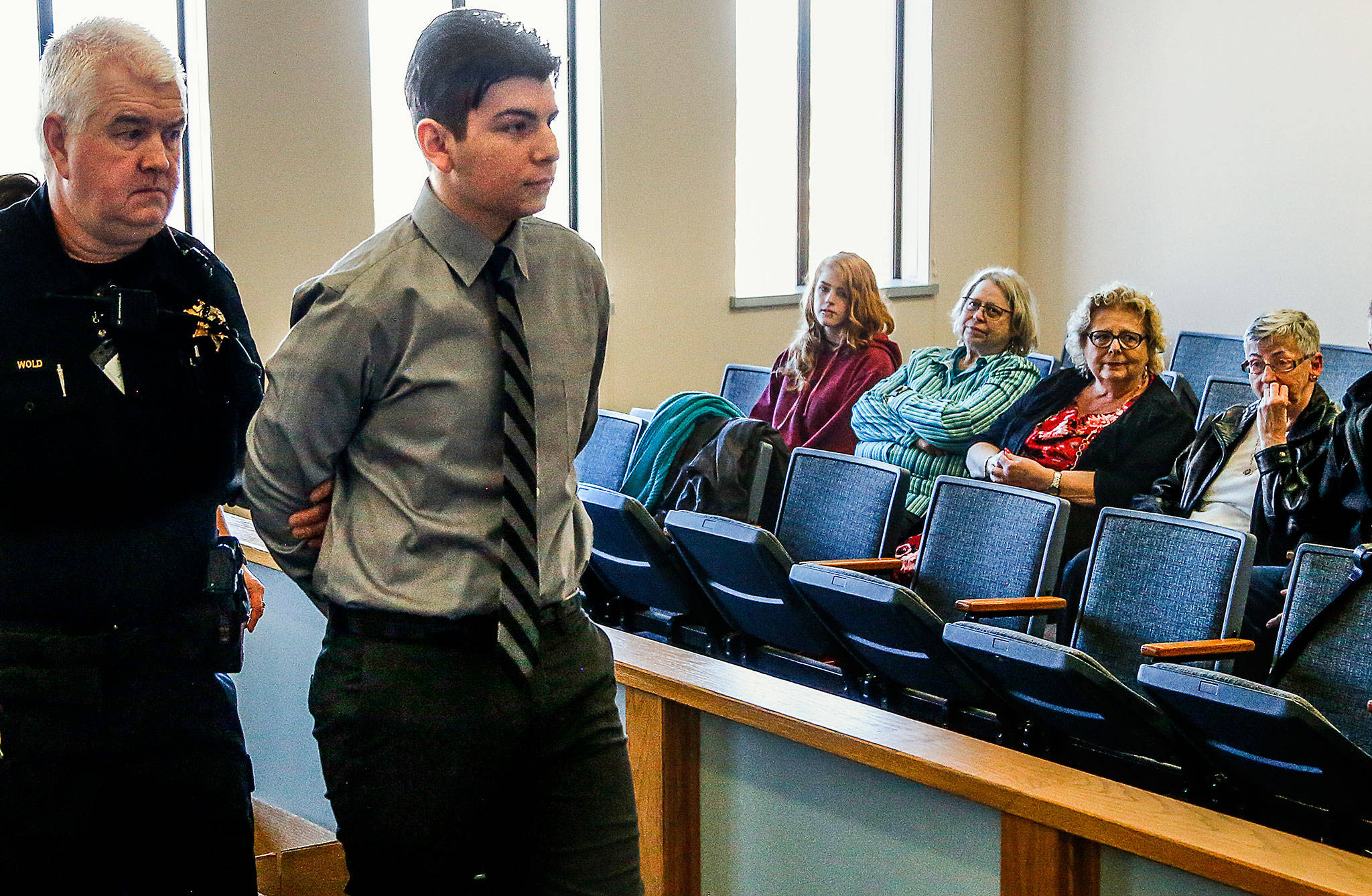 Following a sentence of 22½ years in prison by Superior Court Judge Bruce Weiss, Joshua O’Connor is led out of the courtroom Thursday, past his grandmother, Catherine Katsel O’Connor (far right). (Dan Bates / The Herald)