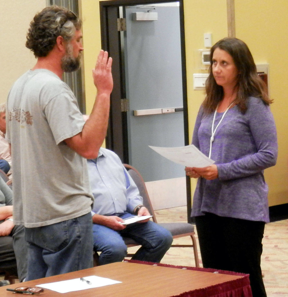 Jeff Daniel takes the oath of office from Finance Director Angela Folkers after being chosen for the open seat on the Ocean Shores City Council on Aug. 13, 2018. (Angelo Bruscas/North Coast News, file)

